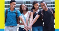 a group of young people holding hands in front of a yellow background